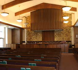 Chapel featuring pendant lighting, raised dais, and high vaulted ceiling