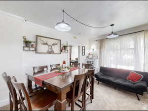 Dining area featuring light colored carpet