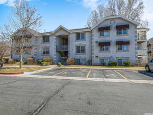 View of property featuring uncovered parking