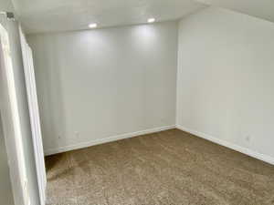 Carpeted empty room with baseboards