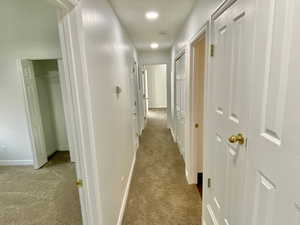 Hallway featuring carpet floors and recessed lighting