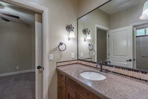 Bathroom featuring vanity and carpet