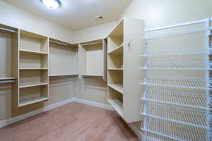 Walk in closet featuring light wood-type flooring