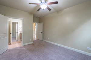 Unfurnished bedroom featuring light colored carpet and ceiling fan