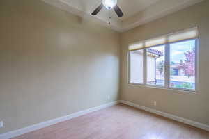 Unfurnished room with light wood finished floors and ceiling fan