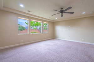 Spare room featuring light colored carpet, a ceiling fan, and recessed lighting