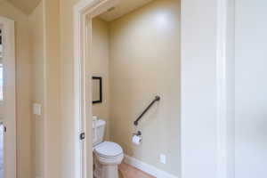 Bathroom with baseboards and toilet