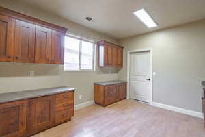Laundry room with light wood-style floors and baseboards