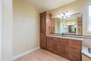 Bathroom featuring vanity and light wood-style floors
