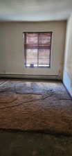 Spare room with baseboard heating
