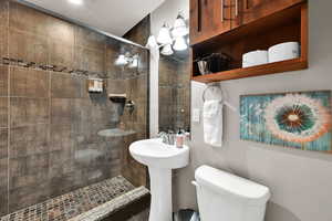 Bathroom with toilet and a tile shower