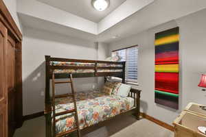 Bedroom featuring light colored carpet and baseboards