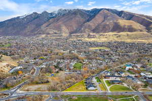 Aerial overview of property's location featuring nearby suburban area and a mountain backdrop