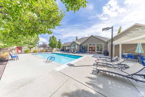 Community pool featuring a patio, a pergola, french doors, and grilling area