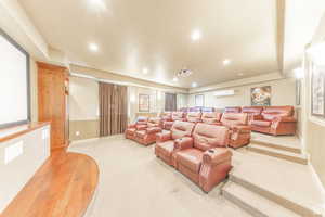 Carpeted cinema room featuring recessed lighting and a wall mounted air conditioner