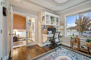 Office space featuring dark wood-type flooring and french doors
