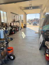 Garage with a workshop area and freestanding refrigerator