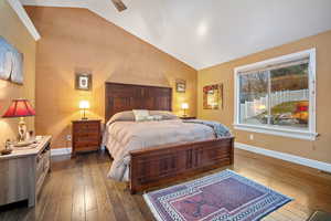 Bedroom featuring lofted ceiling, dark wood finished floors, and ceiling fan
