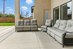 Fenced backyard with an outdoor hangout area and a patio area