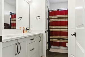 Bathroom with double vanity and curtained shower