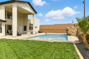 View of swimming pool featuring a patio, a fenced backyard, and a pool with connected hot tub