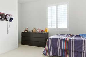 Carpeted bedroom with multiple windows