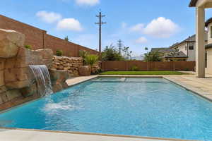 View of pool featuring a fenced backyard and a patio area