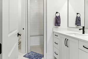 Bathroom featuring vanity and a shower stall