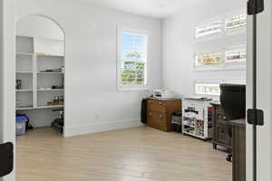 Office space/bedoom, featuring light wood-style flooring and plenty of natural light
