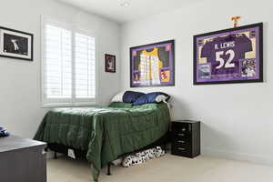 Carpeted bedroom with baseboards
