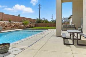 View of pool with a fenced backyard, a patio area, outdoor lounge area, and a pool with connected hot tub