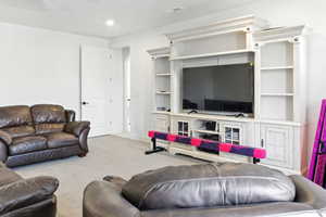 Carpeted living room with recessed lighting
