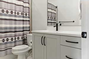 Full bathroom featuring a shower with shower curtain and vanity