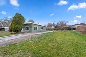 View of side of property featuring a lawn