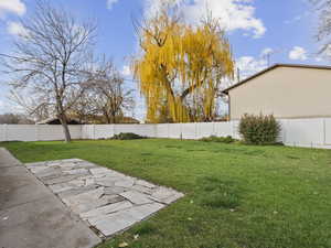Fenced backyard with a patio