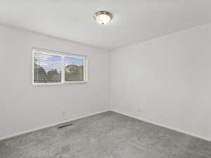 Empty room with carpet and baseboards