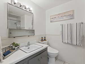 Bathroom with a shower with shower door, vanity, and light tile patterned floors