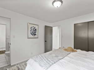 Bedroom featuring a closet and baseboards