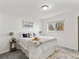 Bedroom featuring carpet flooring and baseboards