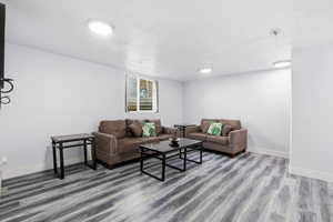 Living area with wood finished floors and baseboards