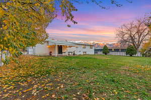 Rear view of house with a patio area, a fenced backyard, and a mountain view