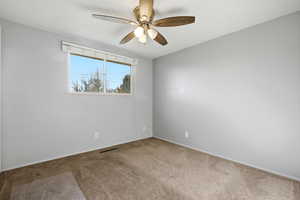 Unfurnished room with carpet, ceiling fan, and a textured ceiling