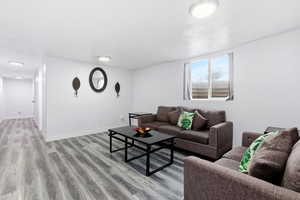 Living area with light wood-style flooring and baseboards