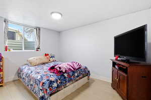 Bedroom with light wood-style flooring and baseboards