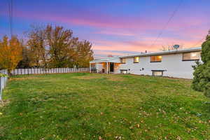 Rear view of property featuring a patio area, a fenced backyard, and brick siding