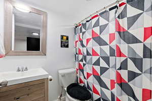 Bathroom featuring curtained shower and vanity
