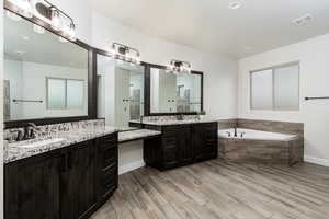 Owners suite bathroom has it all, two vanities, glam counter and large soaking tub