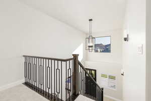 Stairs featuring a chandelier, carpet, and a towering ceiling