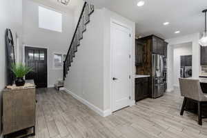 Spacious entry with gorgeous wood tile flooring throughout