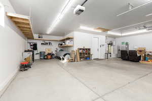 Garage featuring a garage door opener and a central vacuum unit